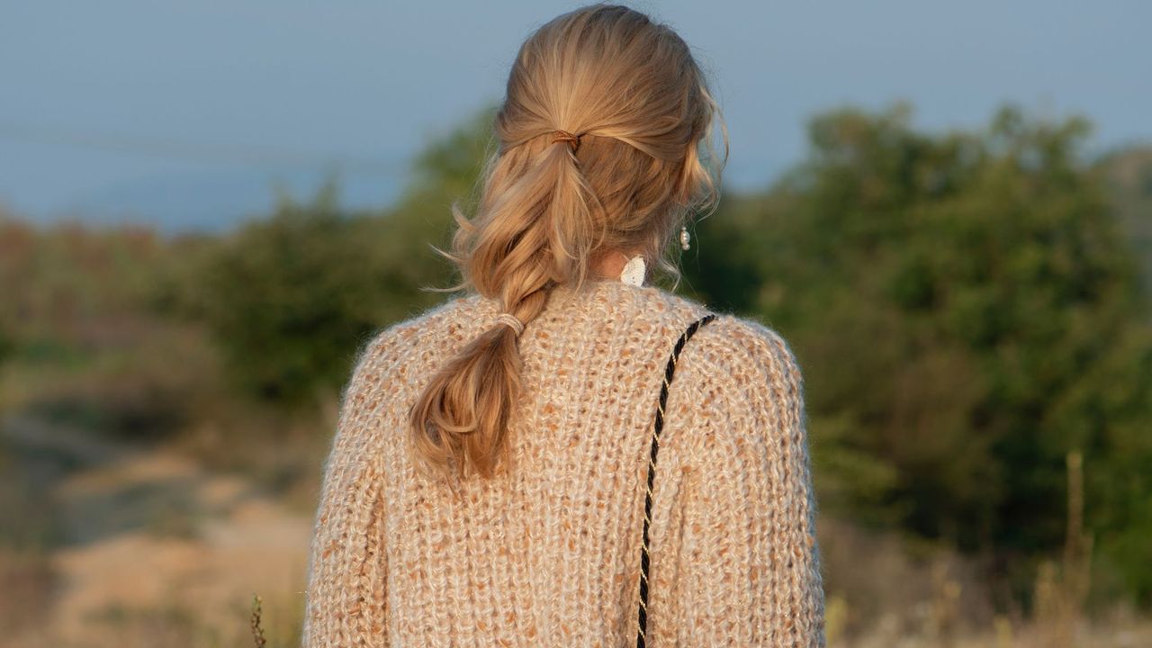 Woman wearing cardigan in a field