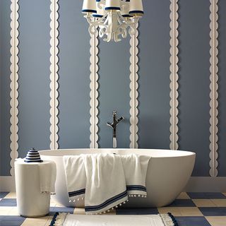 bathroom with chandelier and bathtub