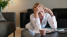 A stock photo of a frustrated woman talking on the phone. 