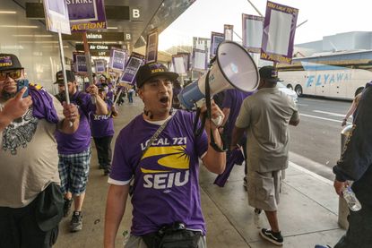 Workers stage a one-day walkout at Los Angeles International Airport. 