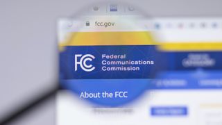 FCC logo on computer screen with magnifying glass