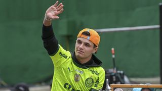 Lando Norris of Great Britain waves to the crowd in an orange McLaren F1 Team cap ahead of the 2024 Brazilian Grand Prix at Interlagos circuit.