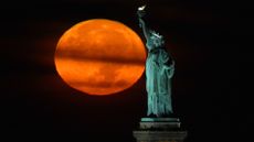 The full harvest moon rises over New York City