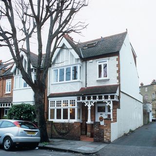 exterior of house with white walls and tree