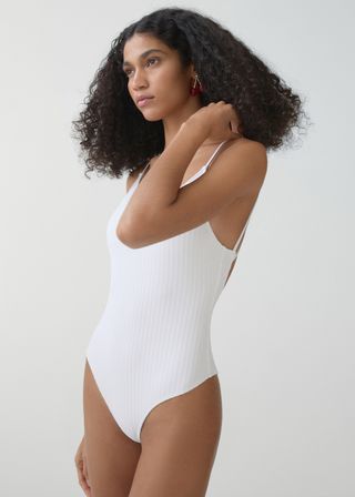 Model wearing v-neck swimsuit