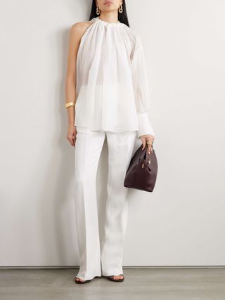 Net a Porter model wearing white sheer blouse and white trousers