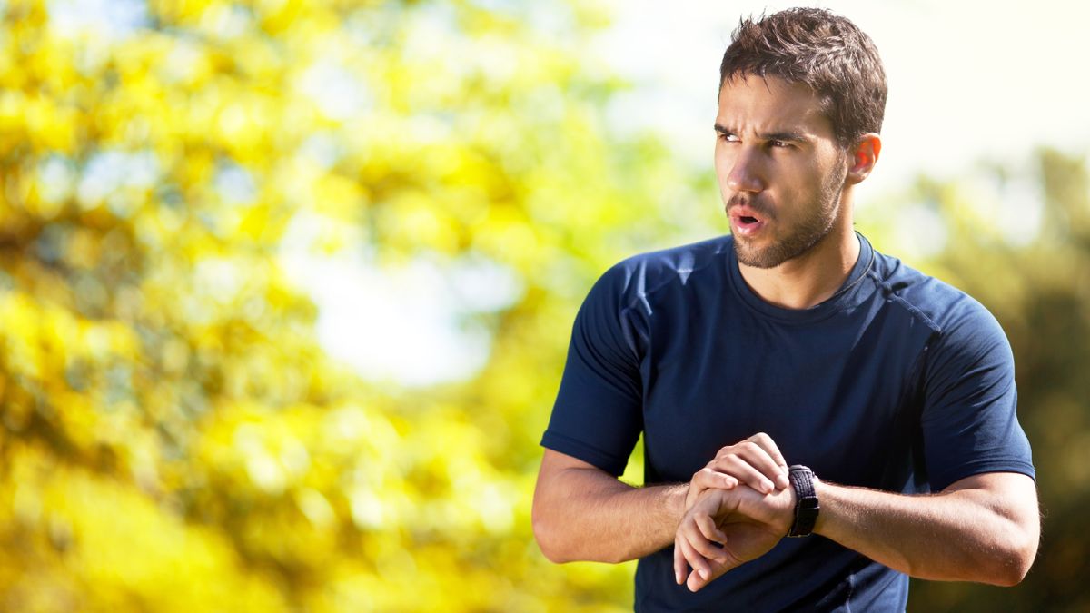 Man checking sports watch during run