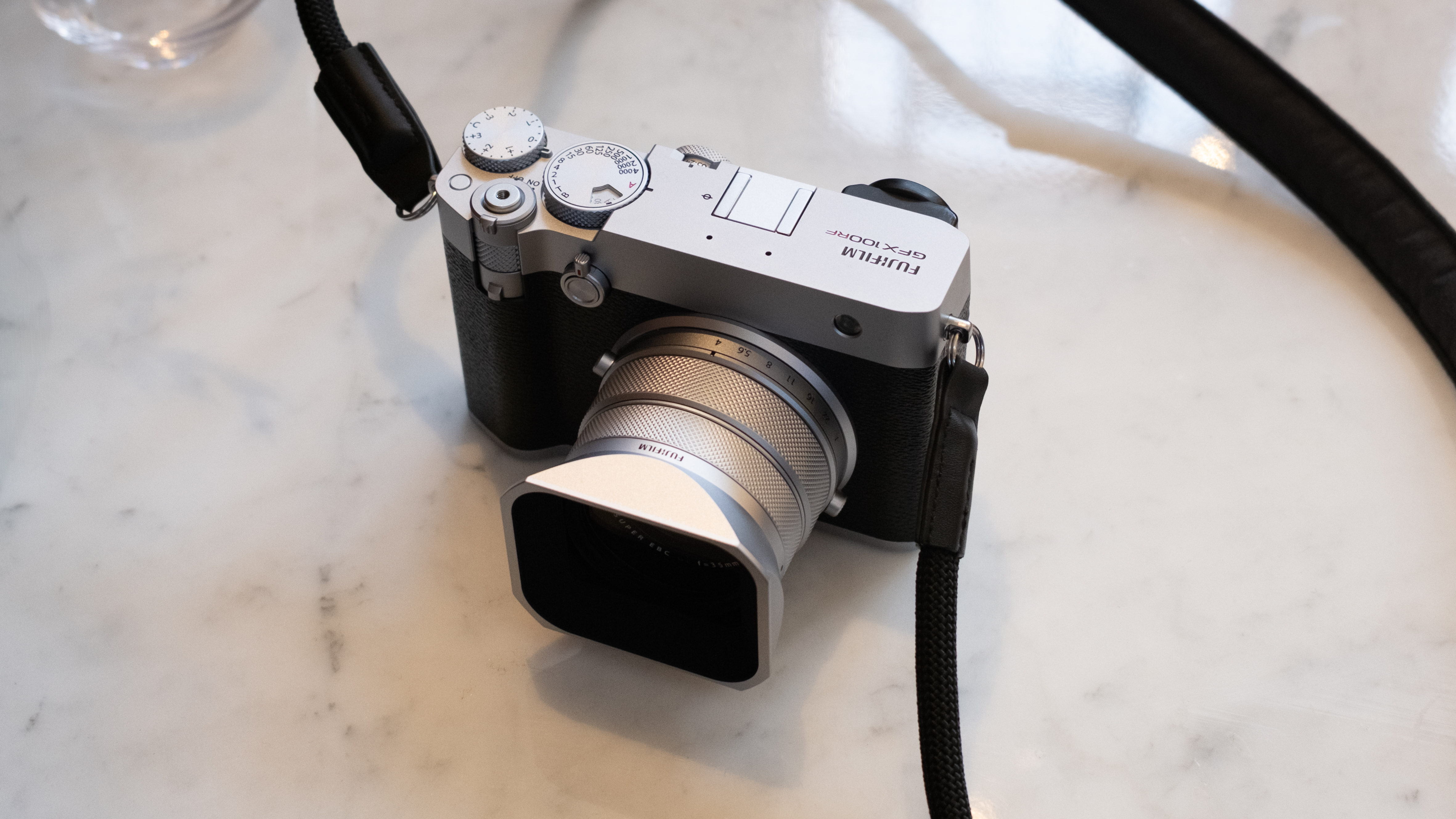 Fujifilm GFX 100RF camera on a marble table