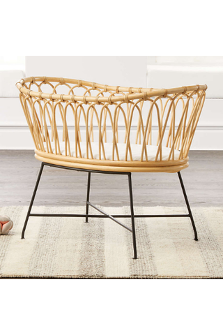 Best bassinets, image shows rattan bassinet with black steel legs