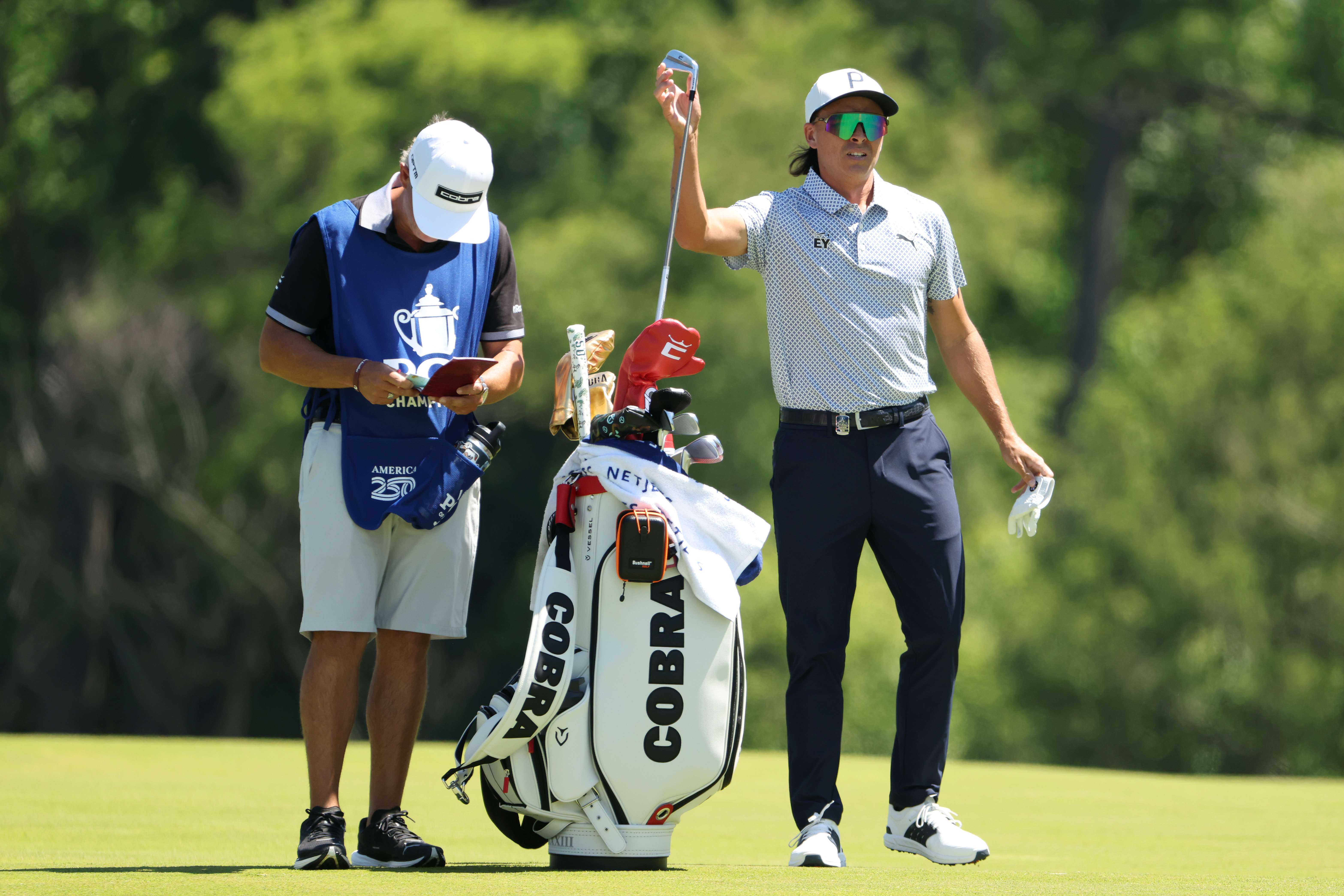 Rickie Fowler of the United States pulls a club from his bag while playing the fourth hole during the third round of the PGA Championship at Aronimink Golf Club