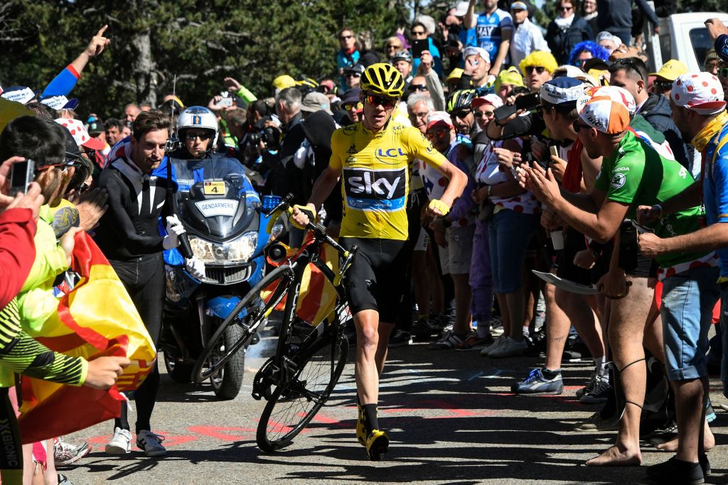 Great Britain's Christopher Froome (C), wearing the overall leader's yellow jersey, carries his bike after falling during the 178 km twelvelth stage of the 103rd edition of the Tour de France cycling race on July 14, 2016 between Montpellier and Chalet-Reynard. (Photo by BERNARD PAPON / POOL / AFP) (Photo by BERNARD PAPON/POOL/AFP via Getty Images)
