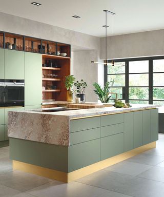 Green kitchen with island and stone countertop