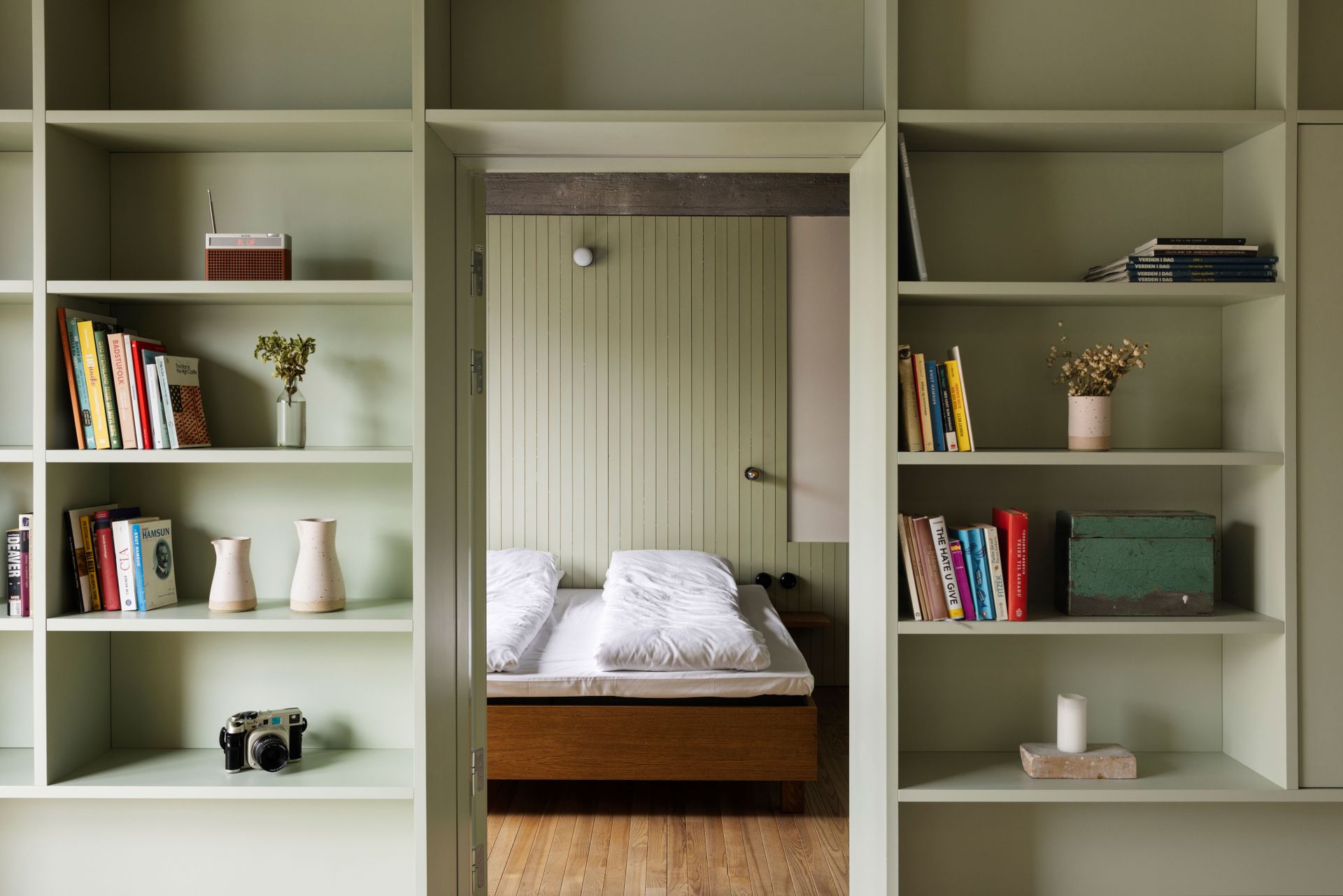 Pale green shelving in bedroon at Trevarefabrikken hotel Norway