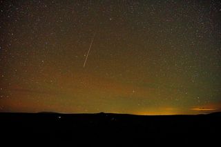 A Draconid meteor streaks across the starry sky over Taos, New Mexico, in this photo taken by Mike Lewinski on Oct. 5, 2018.