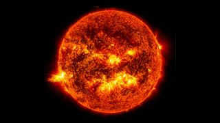 Image of the sun glowing dark orange and bright yellow flares and patches across the 'surface'