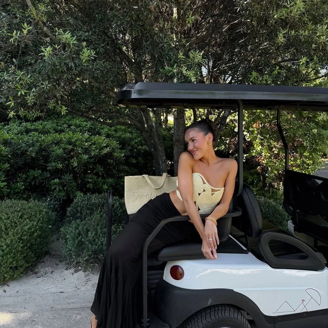 Emma Leger in Saint-Tropez with tan skin and a slicked-back bun