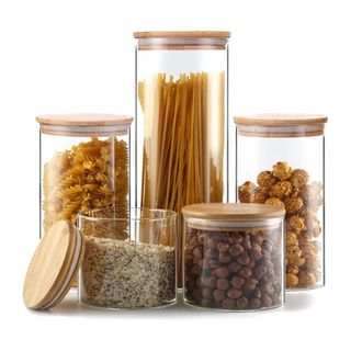 Glass storage jars filled with food and wooden lids
