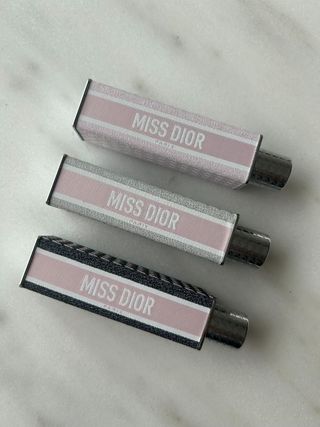 Miss Dior Mini Miss perfumes on a marble table