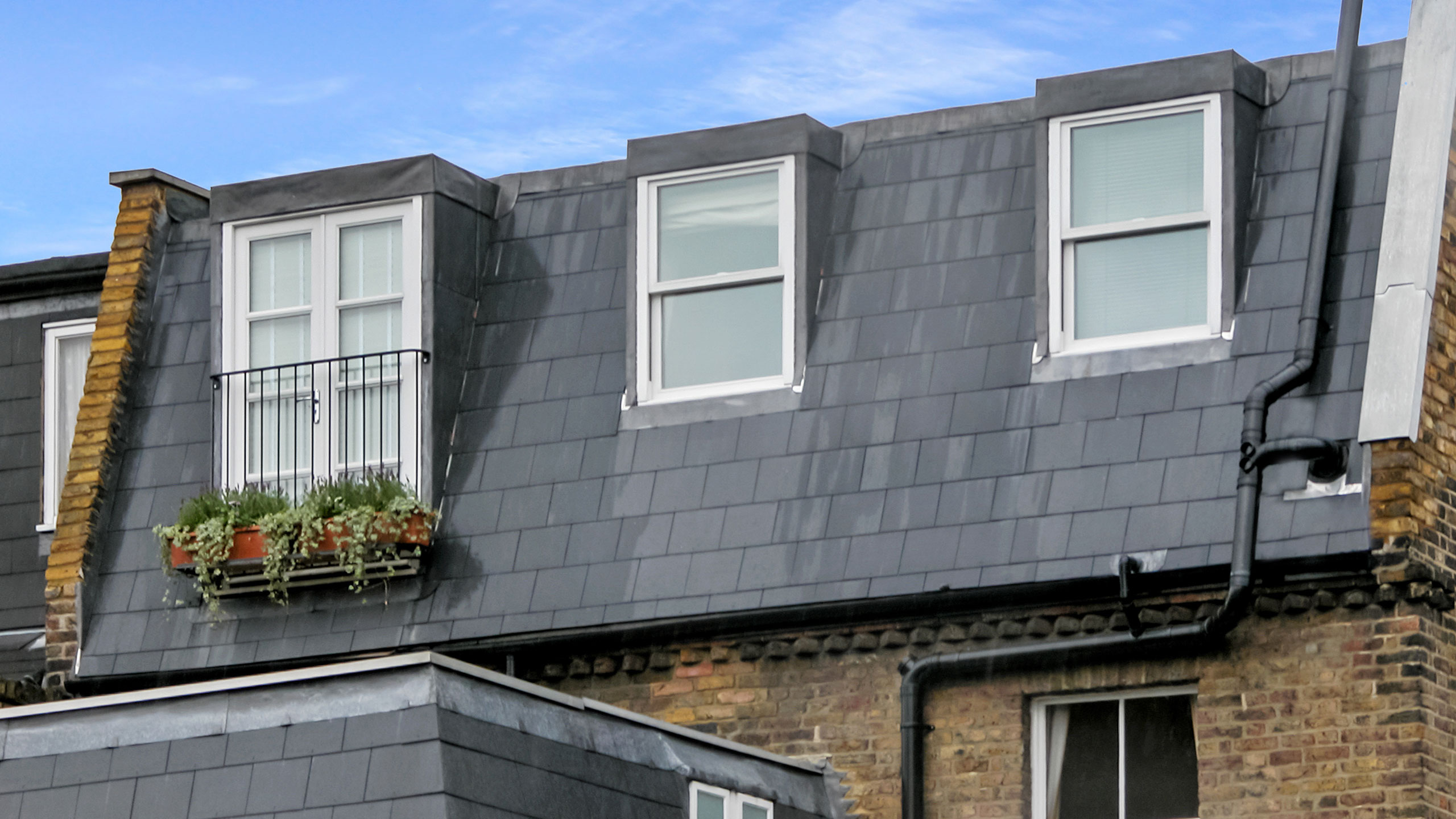 mansard loft conversion with flat cladding and French doors with Juliette balcony