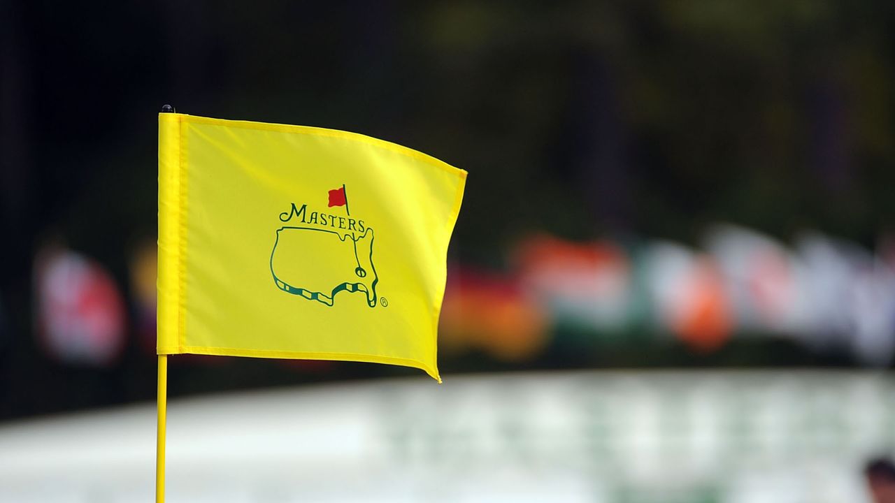 The Masters pin flag in front of the leaderboard at Augusta National golf course