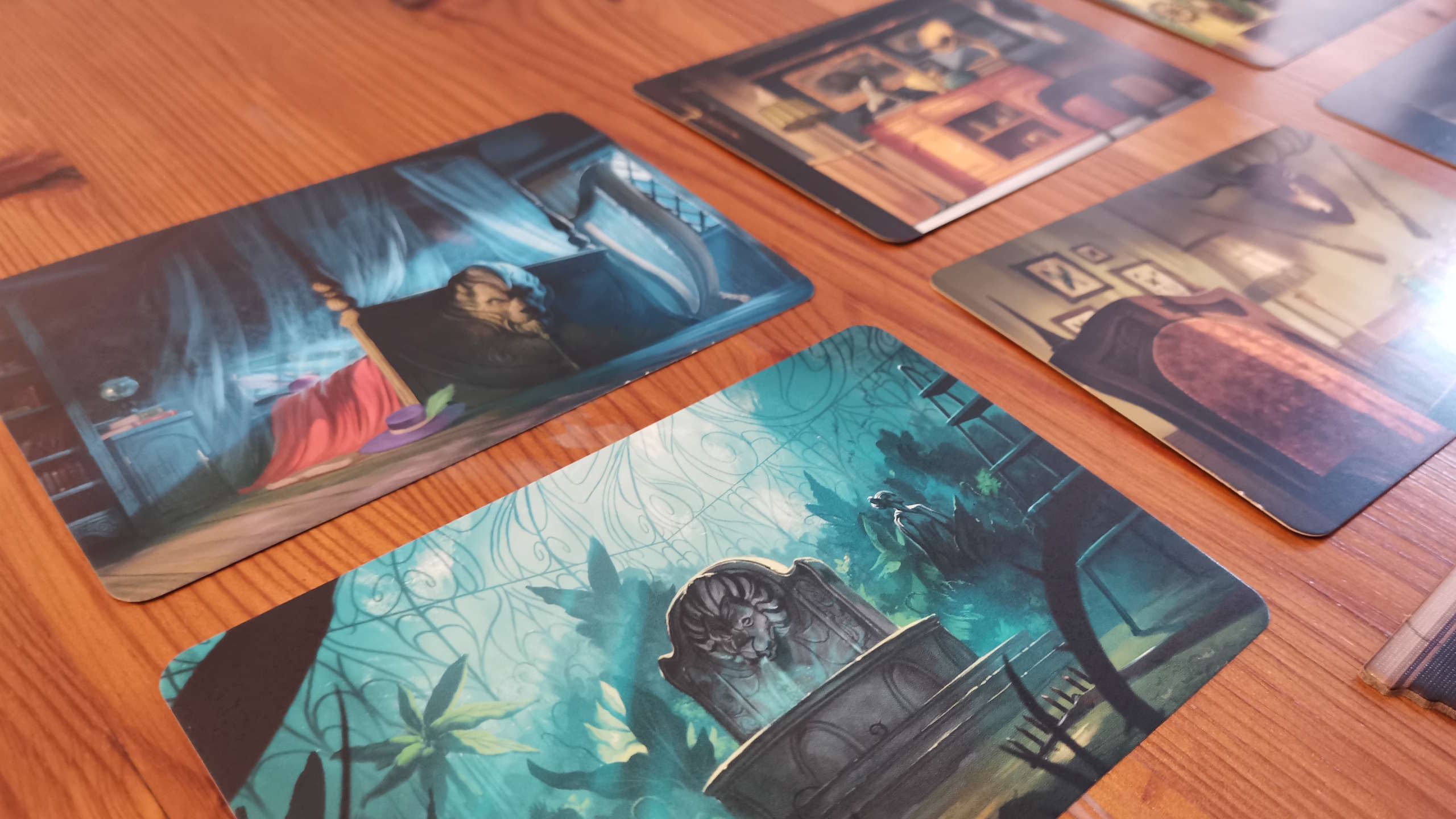 Mysterium location cards laid out on a wooden surface