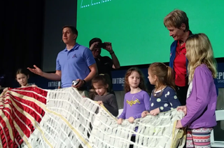 "So this is identical to one of the 11 you'll see on the Exploration Mission-1," Jared Daum, parachute engineer for the NASA Orion spacecraft, said Feb. 24. He invited kids to interact with the parachute prototype on the stage of the show, "So you want to go to Mars?" This event was held for Kids Week 2018 at the Intrepid Sea, Air and Space Museum in New York City.