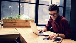 Man works remotely on a laptop