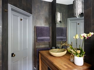 doorway to a small bathroom given a luxury feel with spa-style elements