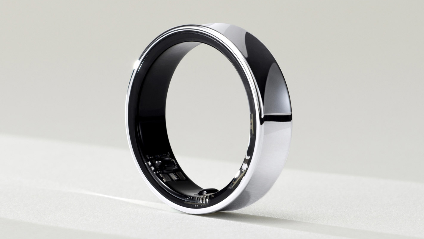 The Samsung Galaxy Ring sitting on a pale surface