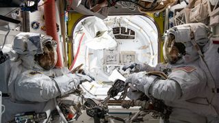 NASA astronauts (from left) Raja Chari and Kayla Barron are pictured inside the U.S. Quest airlock suited up and preparing for a six-hour and 54-minute spacewalk to set up the International Space Station for its next roll-out solar array on March 15, 2022.