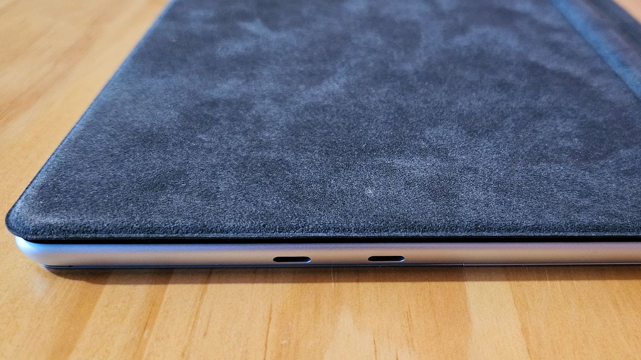 Microsoft surface pro 11 on a table (closed side view)