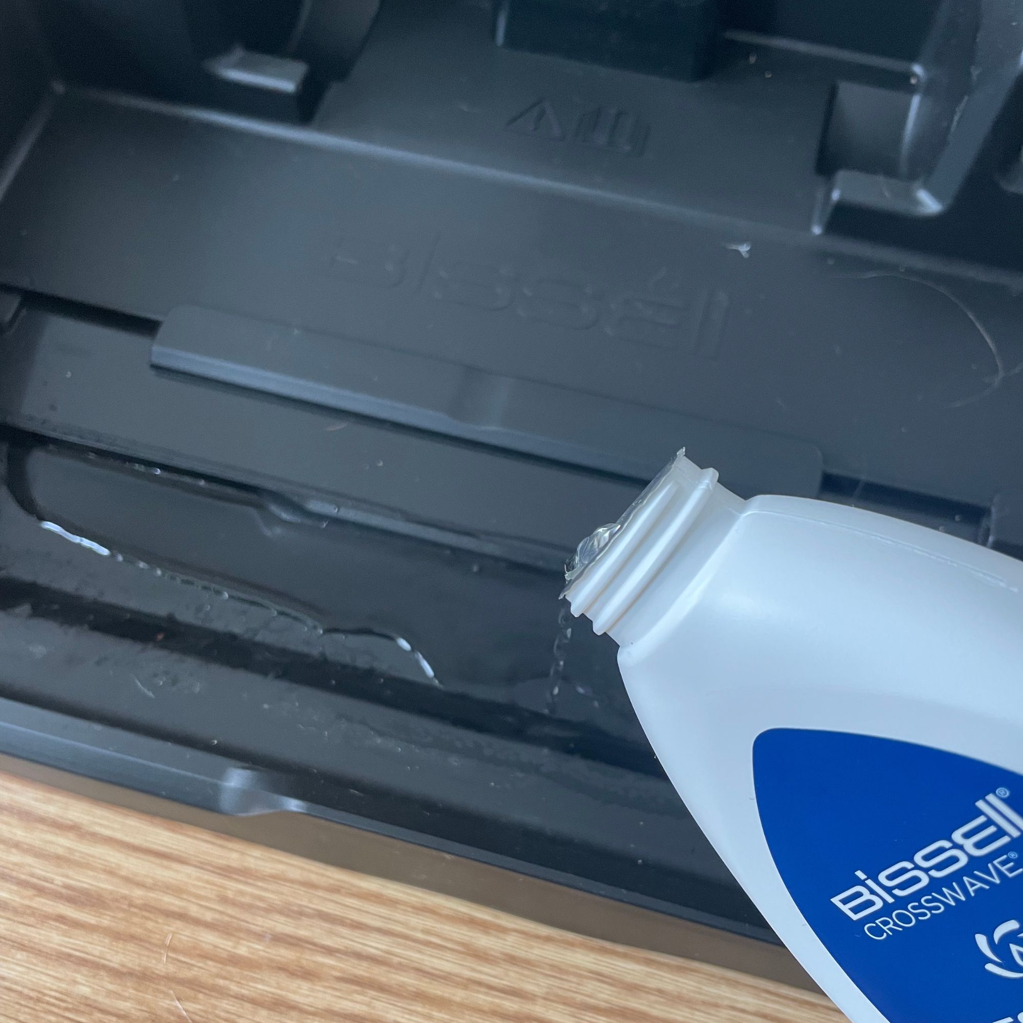 Pouring cleaner into the Bissell Crosswave Omniforce Edge tray