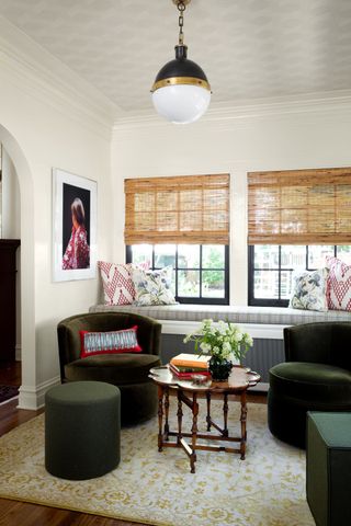 how to make a tiny apartment feel bigger with window seat and curved chairs by M Lavender Interiors