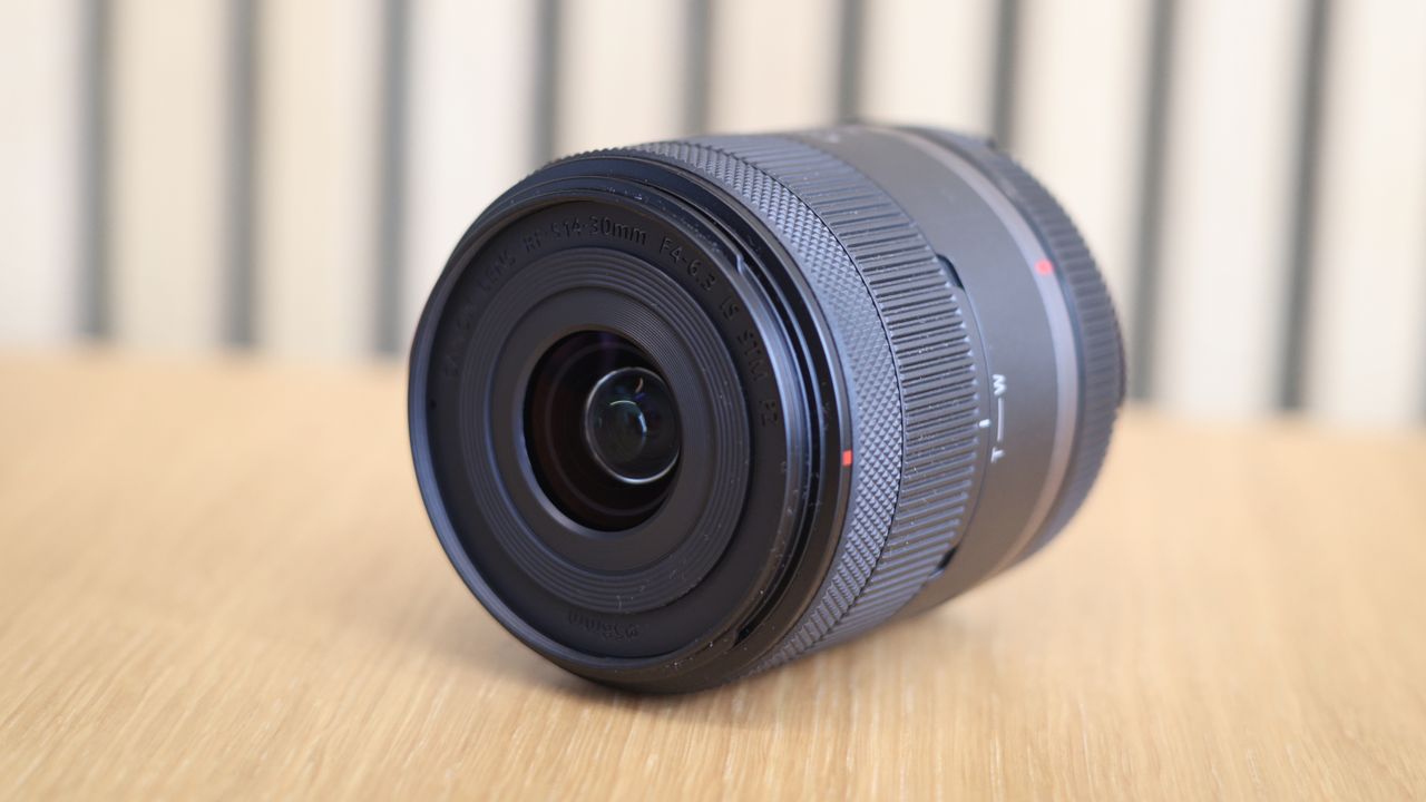 Canon RF 14-30mm f/4-6.3 STM PZ lens on a wooden surface