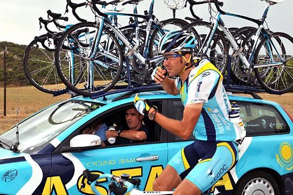 A team Astana rider gets bottles for the team.