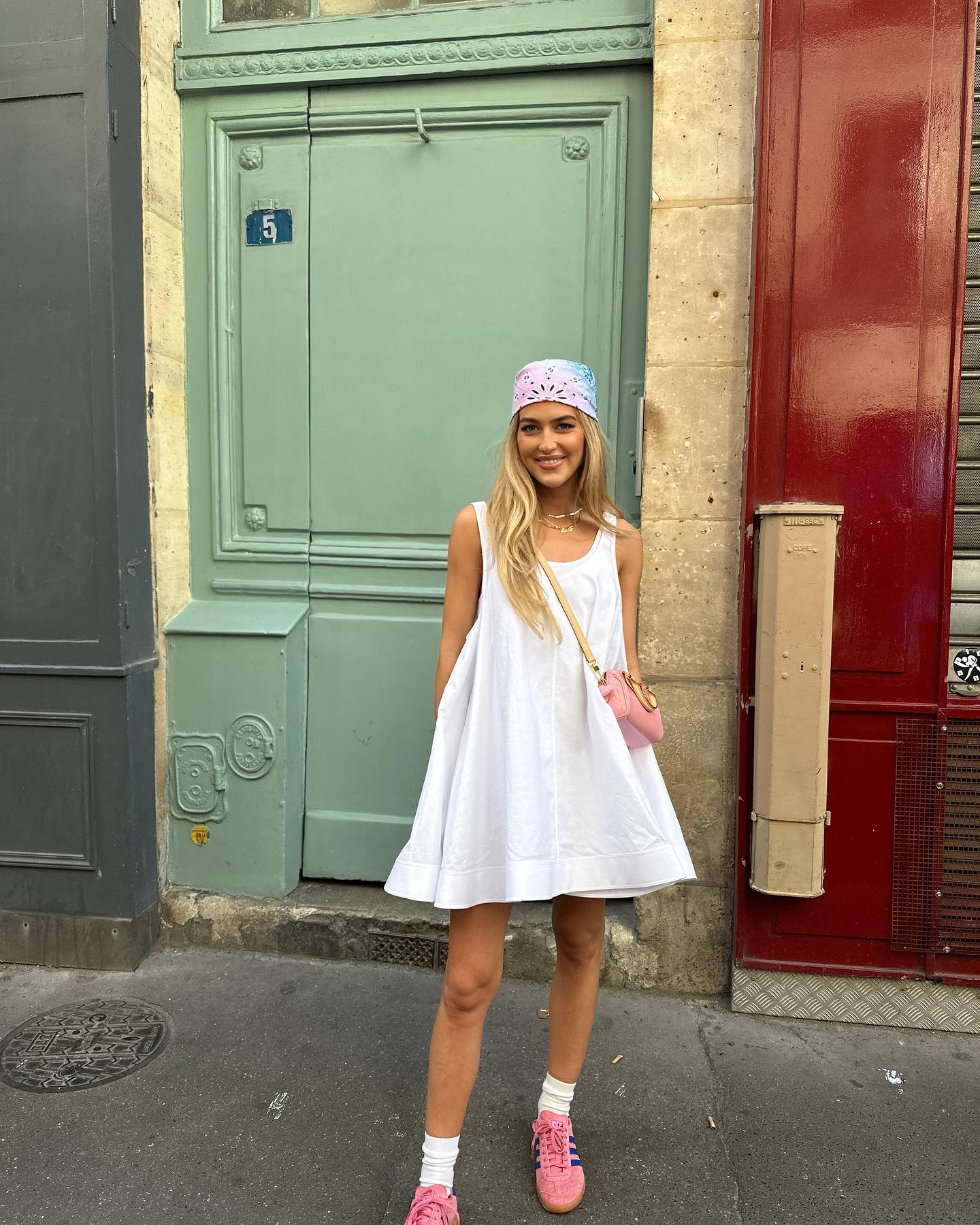 Emili Sindlev wearing a white dress and sneakers
