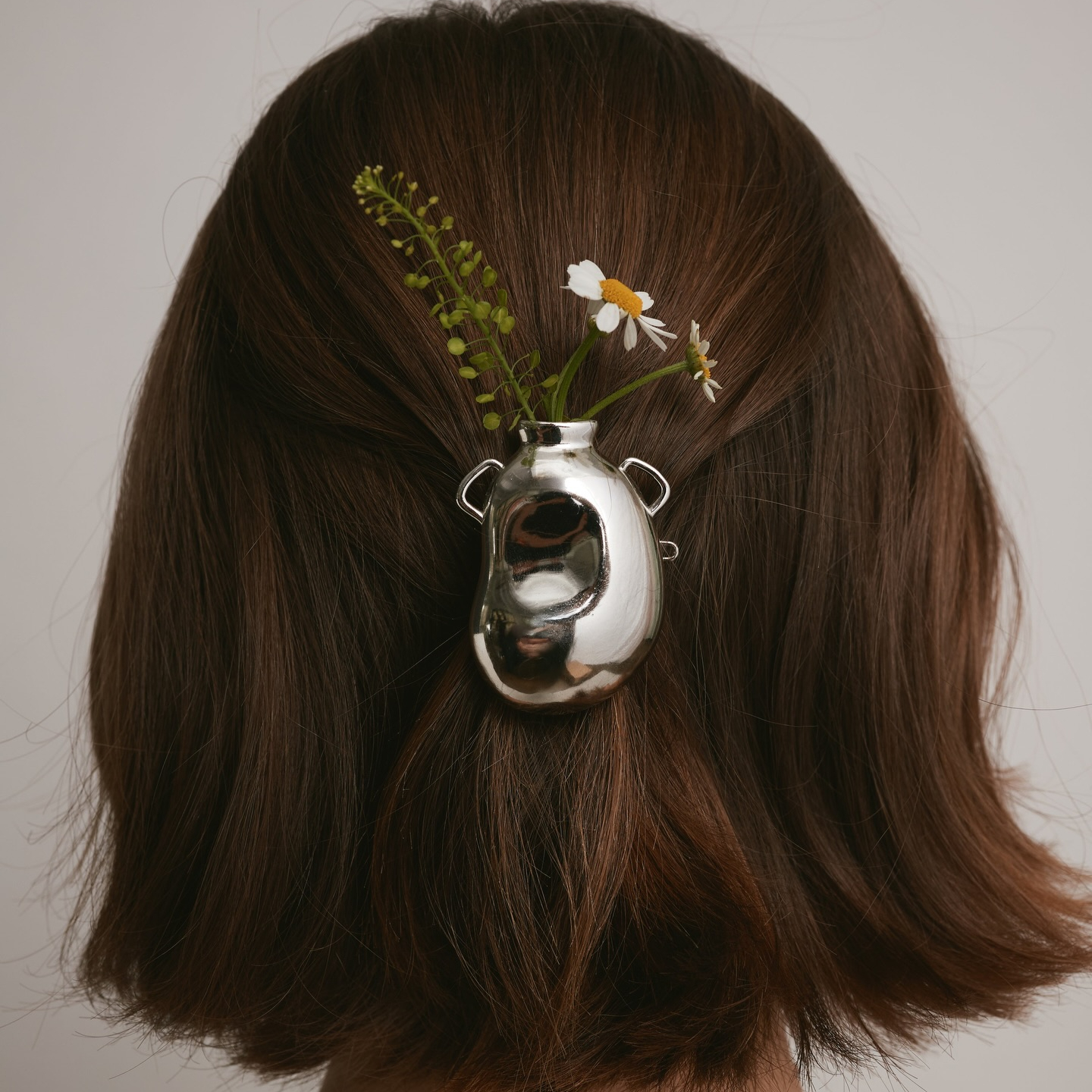Toasty cinnamon hair color on a short bob with a hair clipped