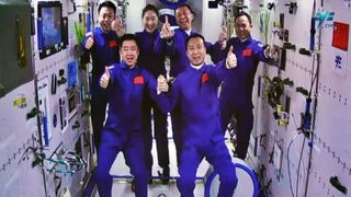 China's Shenzhou 14 and 15 crews pose together aboard the Tiangong space station on Nov. 29, 2022.