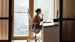 A woman's profile sitting on one of the best office chairs for back pain. 