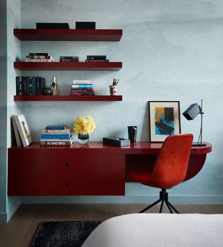 a red built in desk in a blue room
