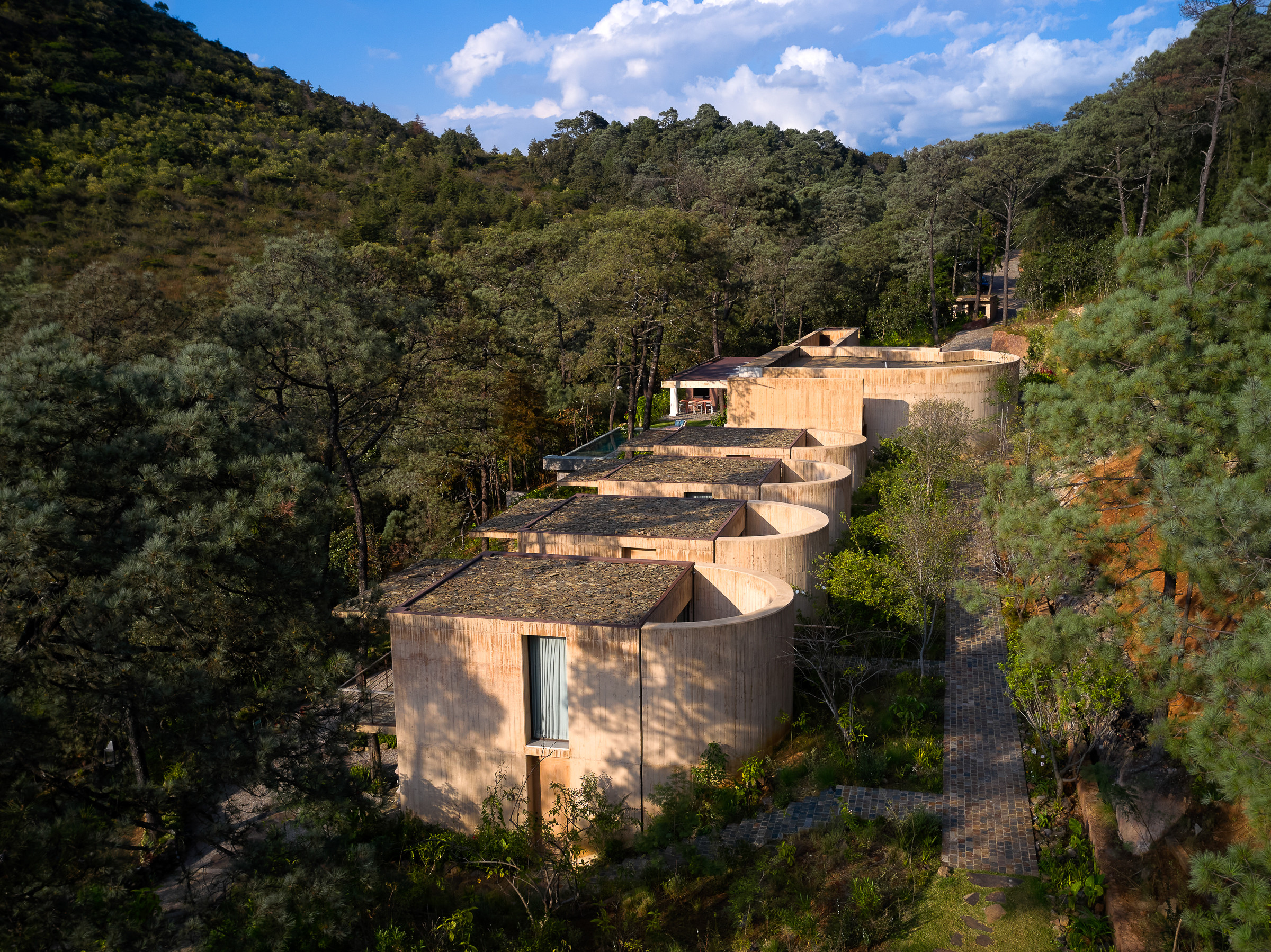The house appears embedded in the hillside