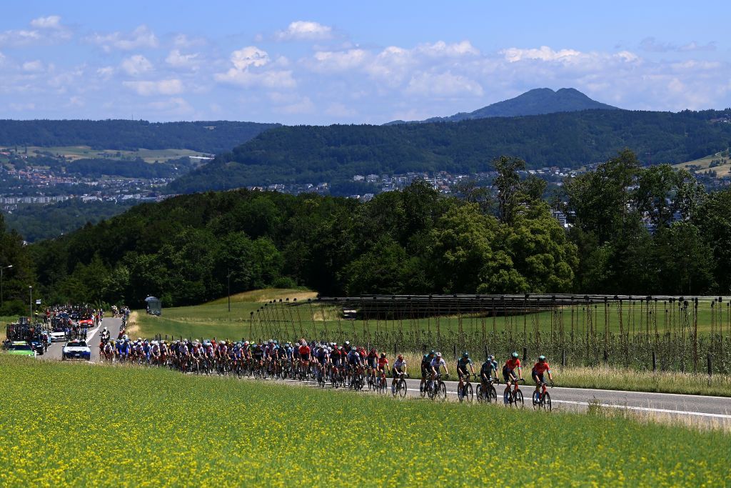 AESCH SWITZERLAND JUNE 13 A general view of the peloton passing through a landscape during the 85th Tour de Suisse 2022 Stage 2 a 198km stage from Kusnacht to Aesch ourdesuisse2022 WorldTour on June 13 2022 in Aesch Switzerland Photo by Tim de WaeleGetty Images