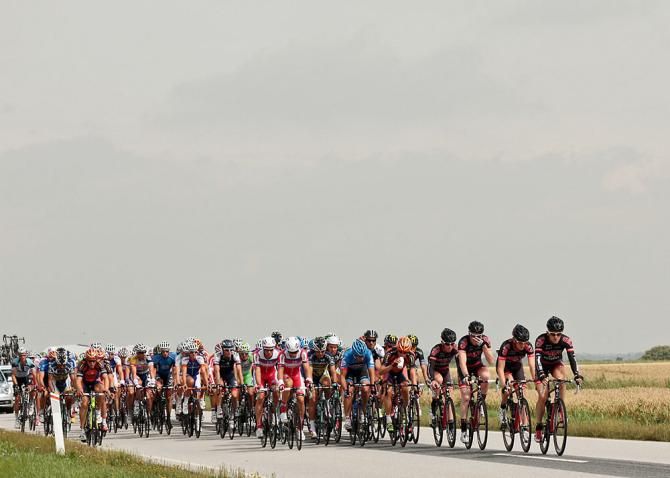 Team CULT Energy working in the chasing peloton to defend the yellow jersey along the southwest coast