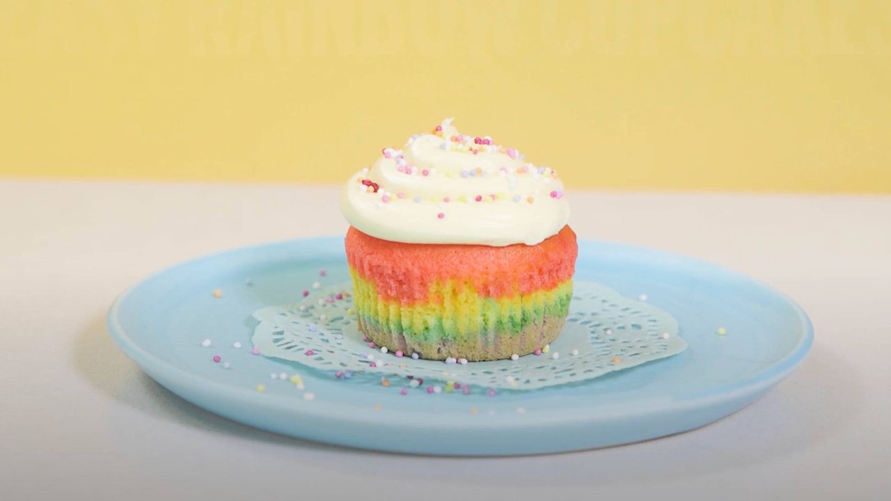 rainbow cupcakes with buttercream frosting on a plate