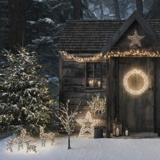 selection of christmas lights outside rustic wooden house