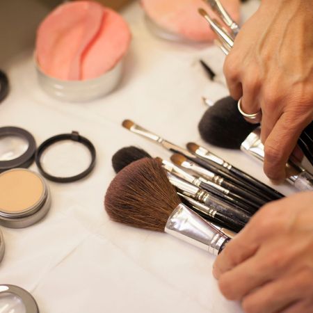 An images showing a person using makeup brushes