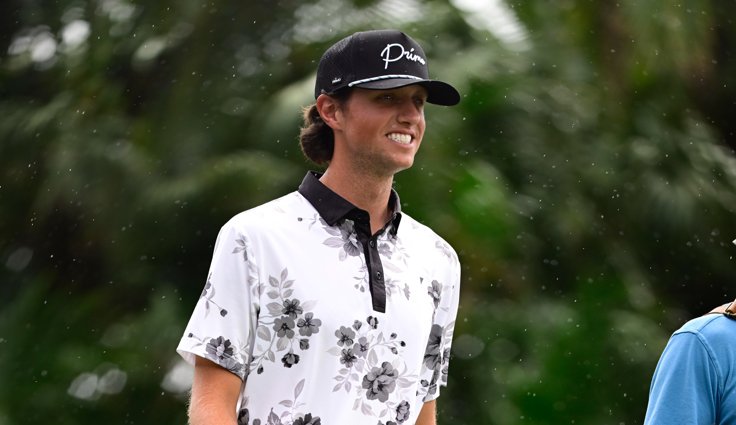 Grant Horvat walks down the fairway smiling