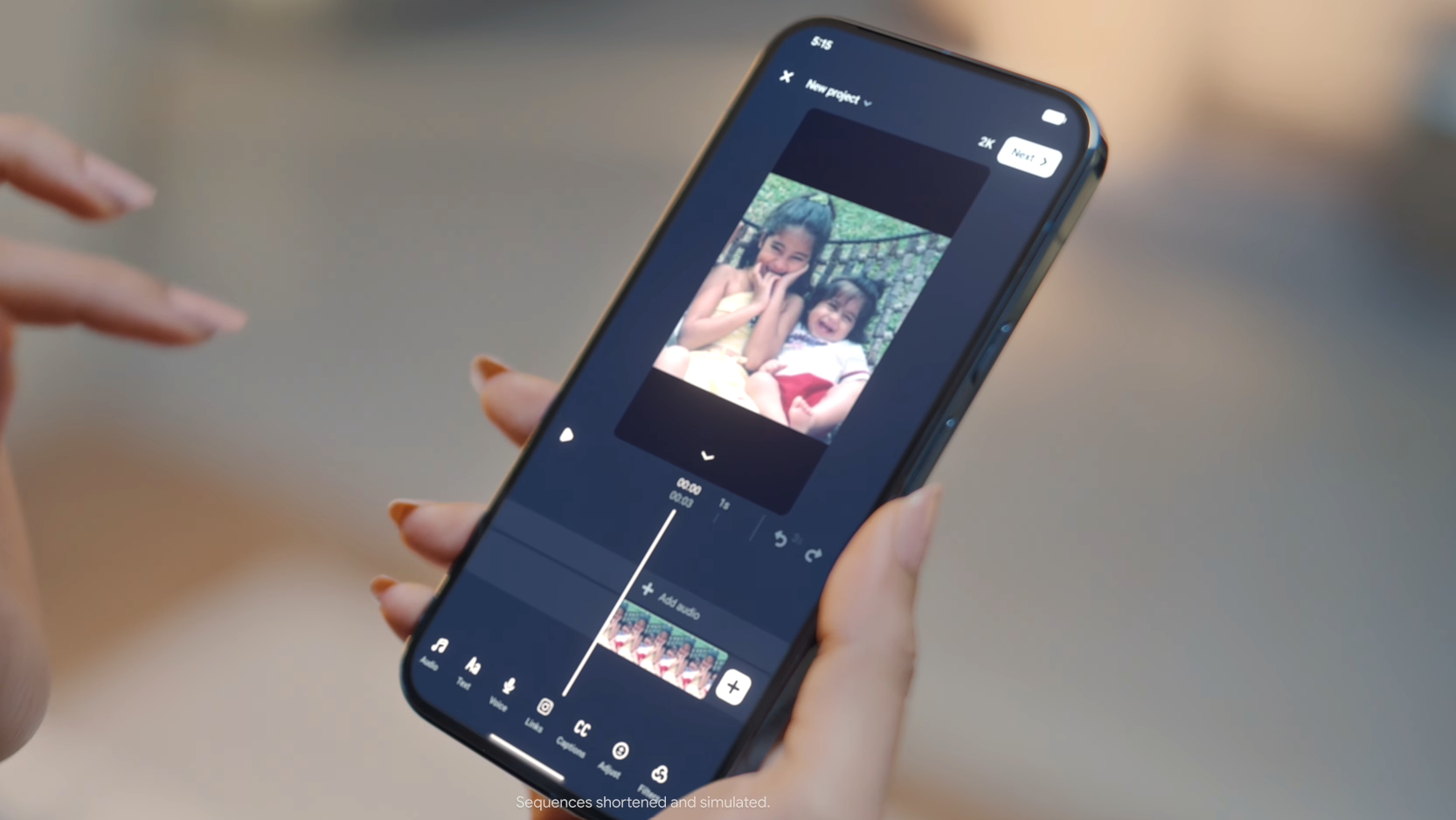 A hand holding a phone, with photo editing tools on screen