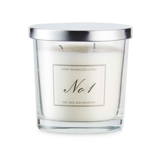 A dual wick Aldi jar candle with a white labels that reads "Luxury fragranced candle - No. 1 - Lime, basil, and mandarin".