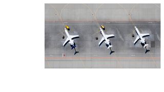 Birds-eye image of two planes on a run way 